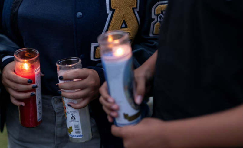 People hold candles during a vigil following the shooting at Apalachee High School, at Jug Tavern Park in Winder, Georgia, U.S.